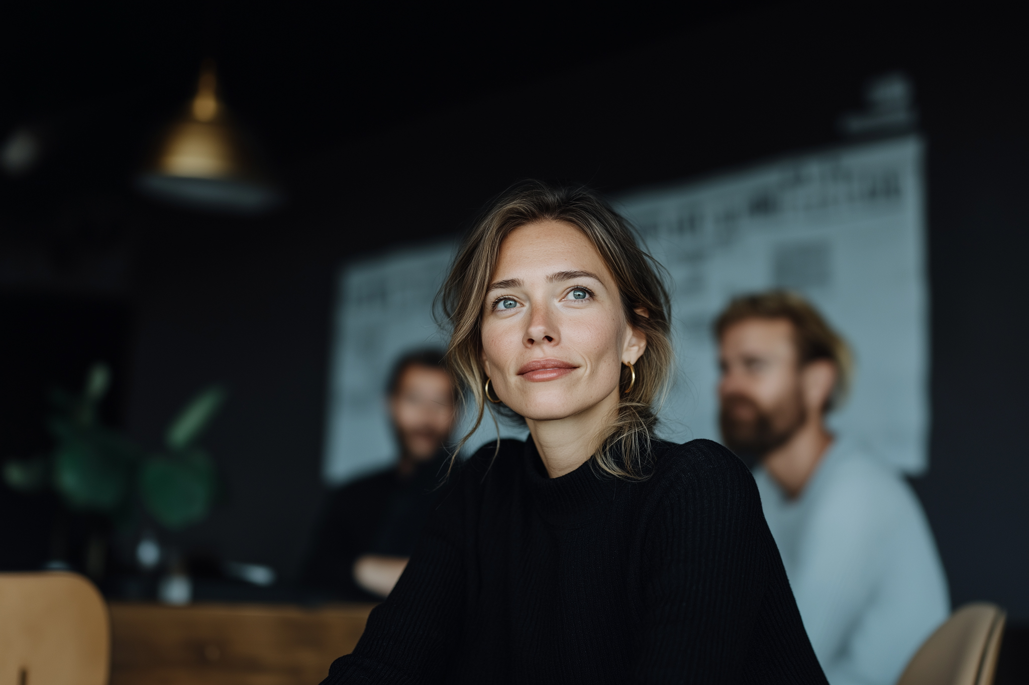 Female executive in a meeting looking thoughtful, representing AI leadership and decision-making in modern organizations