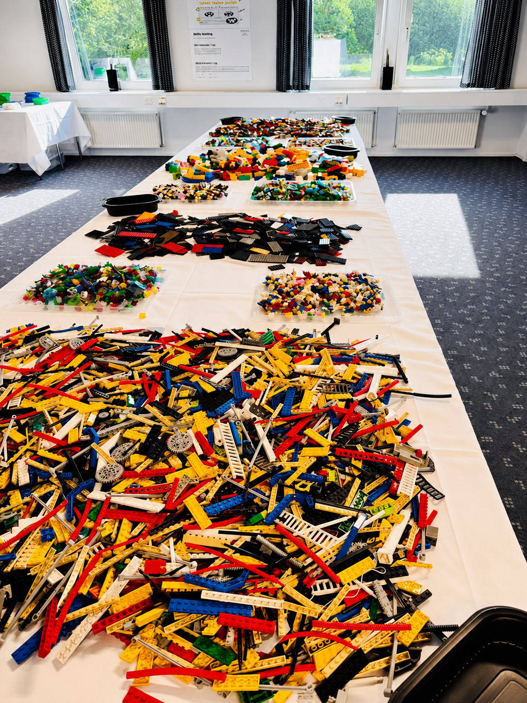 LEGO Serious Play workshop materials sorted on a table for a strategy facilitation session.
