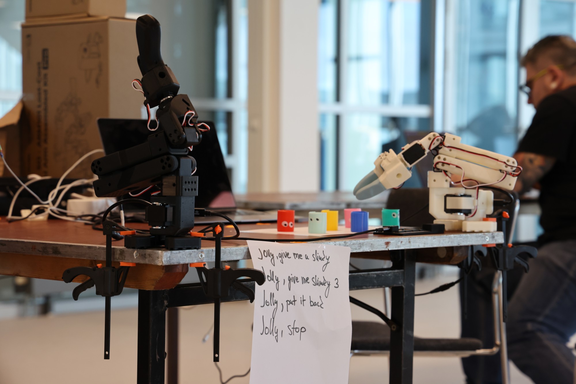 Tech team building a startup demo with Hugging Face SO-101 robotic arms at La Machine robotics hackathon, Tech Makers Amsterdam